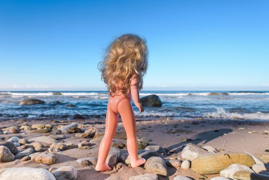 Plastic baby doll on the seashore