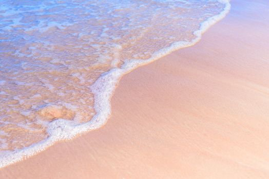 Transparent soft waves on the sandy beach