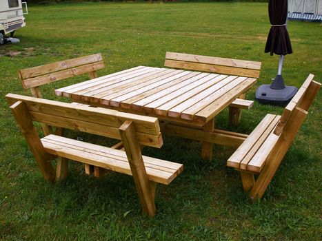 Square Picnic Table made of wood in a camping site