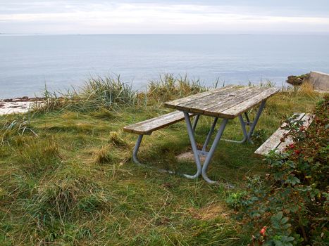 Rustic style Picnic Table made of wood by the beach ocean seaside