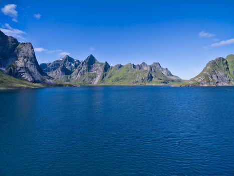 Norwegian fjord surrounded by mountain peaks on Lofoten islands