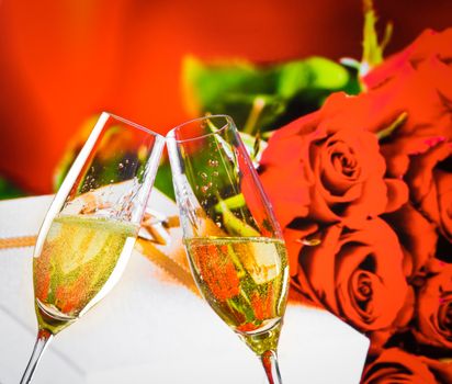 champagne flutes with golden bubbles make cheers on wedding roses flowers background, wedding and valentine day concept