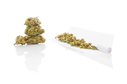 Smoking marijuana. Cannabis abuse. Marijuana bud, hashish, and rolled joint isolated on white background. 