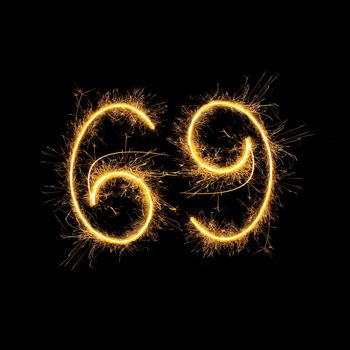 Number 69 in sparkling digits isolated on black background. Symbol of sexual position 69.