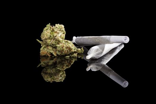 Marijuana background. Cannabis cigarette joint, bud and hemp leaves isolated on black background. Addictive drug or alternative medicine. 