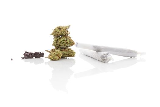 Smoking marijuana. Cannabis abuse. Marijuana bud, hashish, and rolled joint isolated on white background. 