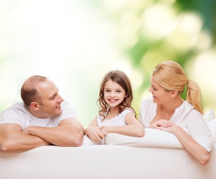 family, childhood, ecology and people - smiling mother, father and little girl over green background