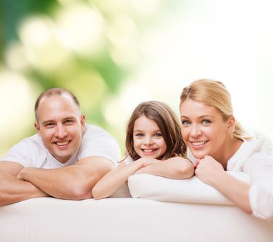 family, childhood, ecology and people - smiling mother, father and little girl over green background