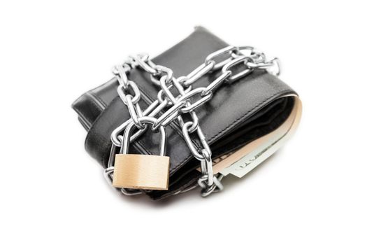 Business safety and finance protection concept - metal chain link with locked padlock on leather wallet full of dollar currency money white isolated
