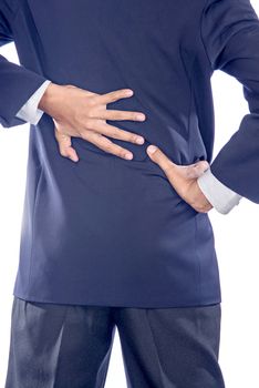 Backache concept bending over in pain with hands holding lower back