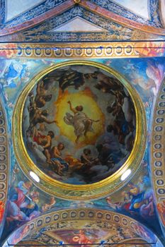 Parma,Italy,25 september 2015.The Vision of St. John the Evangelist at Patmos (1520-1522) is a series of frescoes by the Italian late Renaissance artist Antonio Allegri called Correggio. It occupies the interior of the dome, and the relative pendentives, of the Benedictine church of San Giovanni Evangelista of Parma, Italy.The centre of the cupola is occupied by an illusionistic space based on series of concentric planes indicated by the clouds, from which the apostles stretch out. Starting from the border of the dome, the clouds thin out and open to a shiny light Christ descending towards the floor of the nave. The scene is a faithful rendering of John's Book of Revelation.