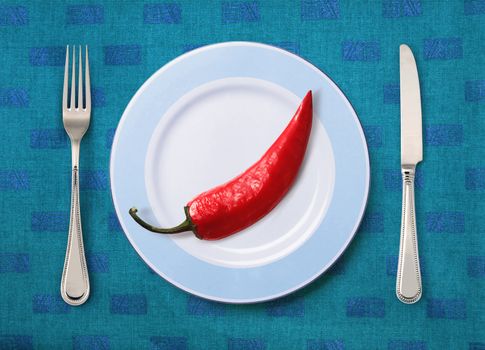 Festive pepper on white plate with knife and fork