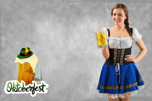 Pretty oktoberfest girl smiling at camera holding beer against oktoberfest graphics