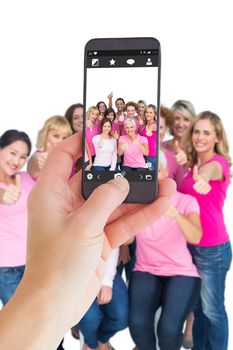 Female hand holding a smartphone against camera