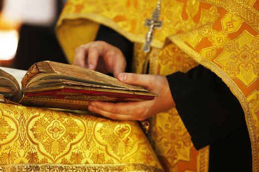 The Bible in hands of the priest