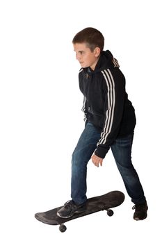 The picture shows a boy riding on a skateboard.