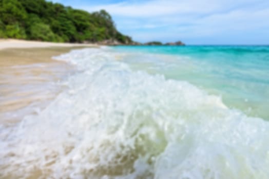Blurred photograph for background, beautiful landscape blue sea and white waves on beach in summer at Koh Miang island, Mu Ko Similan National Park, Phang Nga province, Thailand