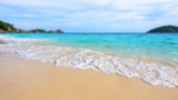 Blurred photograph for background beautiful landscape blue sea and white waves on beach in summer at Koh Miang island, Mu Ko Similan National Park, Phang Nga province, Thailand, 16:9 widescreen