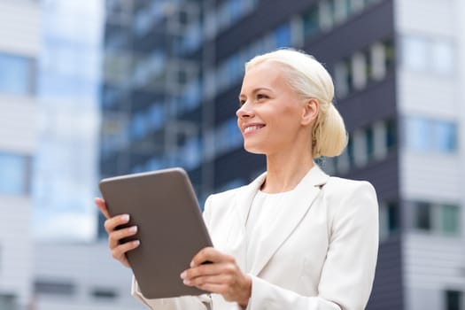 business, education, technology and people concept - smiling businesswoman working with tablet pc computer on city street