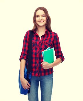 education and people concept - smiling female student with laptop bag and notebooks