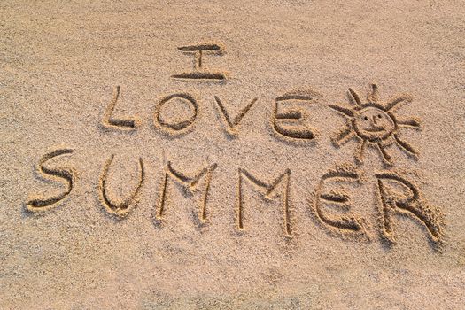 In the picture the writing on the sand "I love summer".