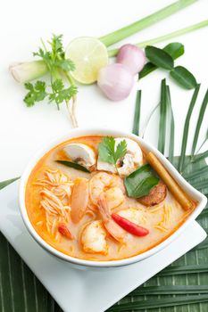 Thai shrimp tom yum soup bowl close up with noodles.