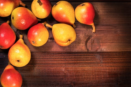 In the picture a set of pears  "Angelica" Typical Italian, placed on wooden boards brown and empty space on the right.