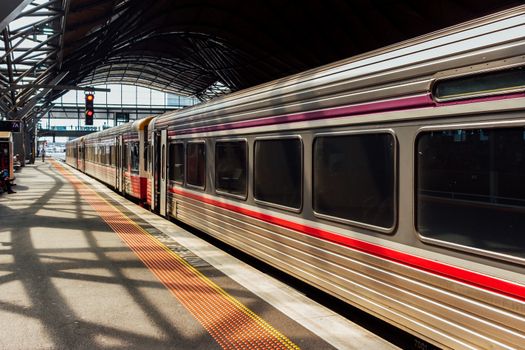 A regional Diesel powered train waiting at its terminal for departure.