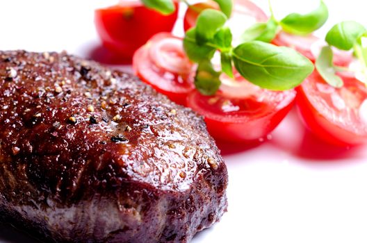 Grilled steak with tomatoes and oregano leafs
