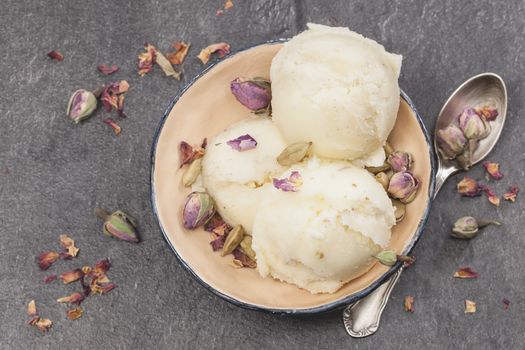 Ice cream made with rose petal, cardamom, vanilla and pistachios. Macro, very shallow depth of field