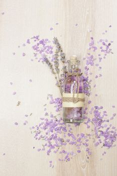 Aromatherapy lavender bath salt and massage oil on wooden background