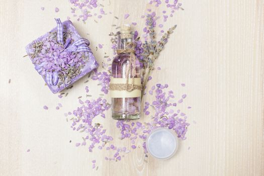 Various lavender beauty products on the wooden board.