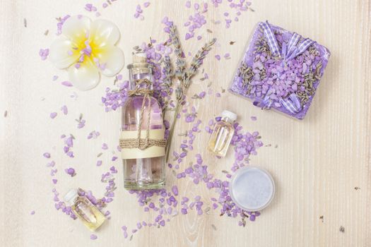 Various lavender beauty products on the wooden board.