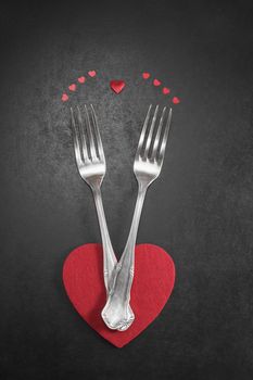 Valentines dinner table setting in rustic style with cutlery Romantic dinner concept. Done with a vintage retro filter