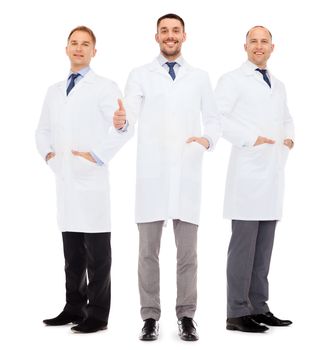 healthcare, profession and medicine concept - smiling male doctors in white coats over white background