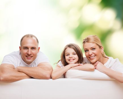 family, childhood, ecology and people - smiling mother, father and little girl over green background