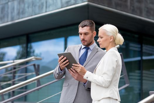 business, partnership, technology and people concept - businessman and businesswoman working with tablet pc computer on city street