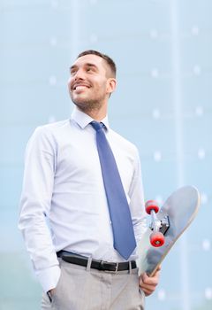 business, hot drinks and people and concept - young smiling businessman with skateboard outdoors