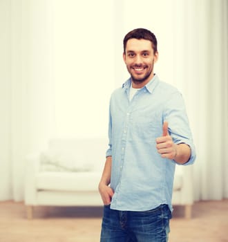 happiness, gesture and people concept - smiling man showing thumbs up