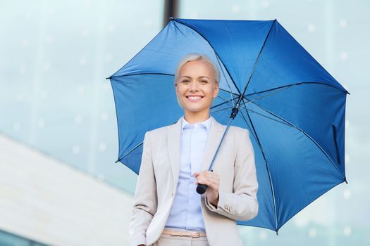 business, bad weather and people and concept - young smiling businesswoman with umbrella outdoors