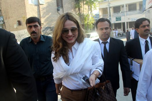 PAKISTAN, Rawalpindi: Singer and model Ayyan Ali walks to a court hearing in Rawalpindi, Pakistan, on October 8, 2015. 	Ali was charged with money laundering�after security forces found over $500,000 in her luggage on a flight destined for Dubai in March. 