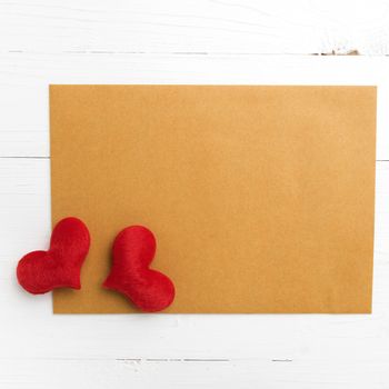 brown paper and heart on white table