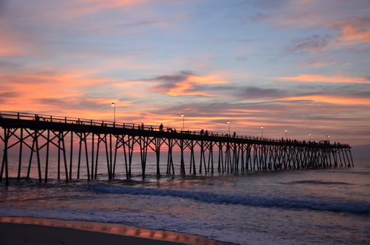 Sunrise at Kure Beach North Carolina on a warm summer morning. Fisherman getting out early.