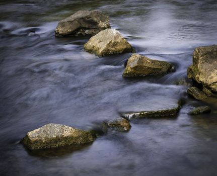 background seasonal autumn calm river with stones