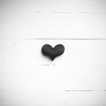 red heart on white table view from above black and white style