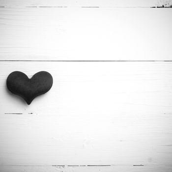 red heart on white table view from above black and white style