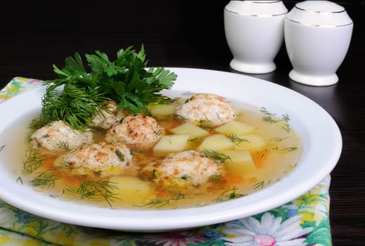 chicken broth of potatoes, carrots and meatballs sprinkled with dill
