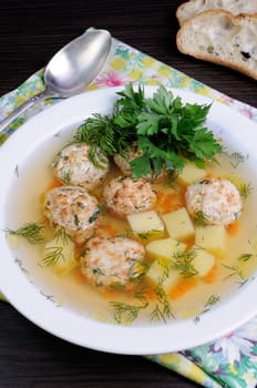 chicken broth of potatoes, carrots and meatballs sprinkled with dill