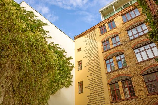 Berlin, Germany - October 26, 2013: Facade of one of the eight yards called "Hackesche Hoefe" in the district Spandauer Vorstadt. They was refurbished in 1993 and host today several shopping malls, galleries and restaurants.
