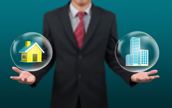 man show house and condominium in bubble on hand